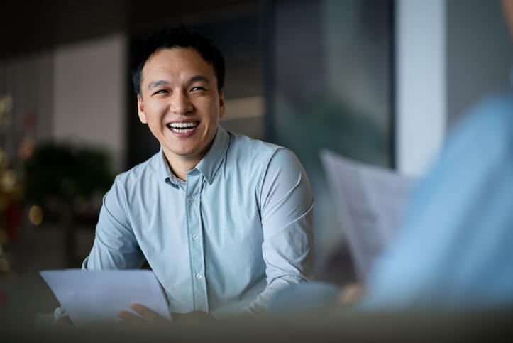 Business analyst chatting with a manger offscreen at the office.